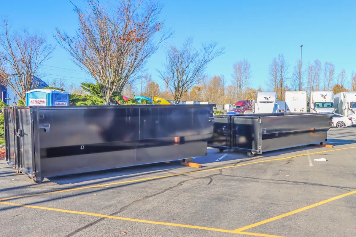 Professional dumpster rental service with roll-off container on residential driveway in Pryor Creek